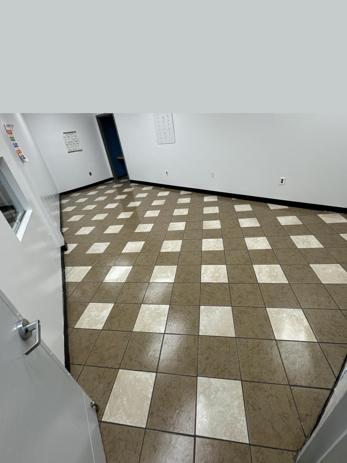 Brown checkerboard tile after stripping and waxing