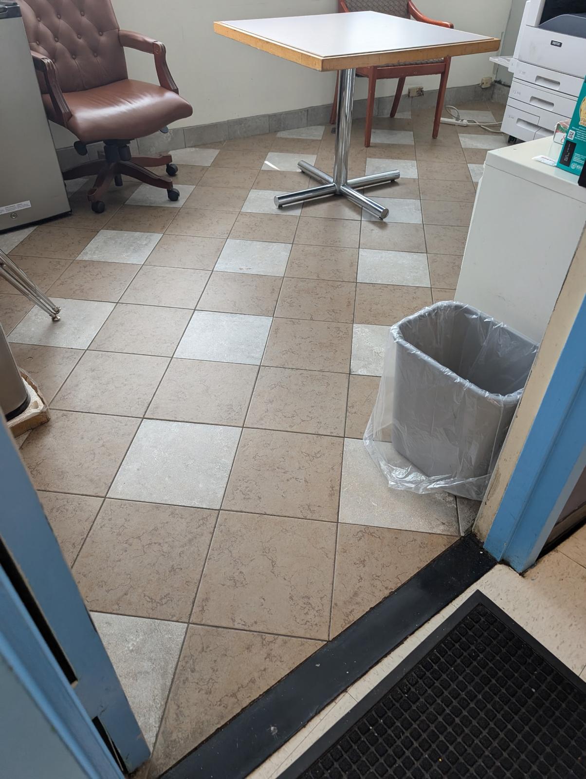 Brown checkerboard tile before stripping and waxing