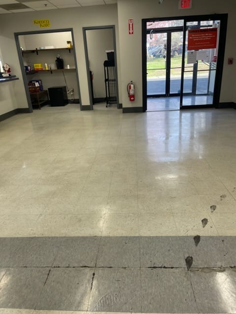 Commercial floor before professional wax application — dulled finish with embedded grime